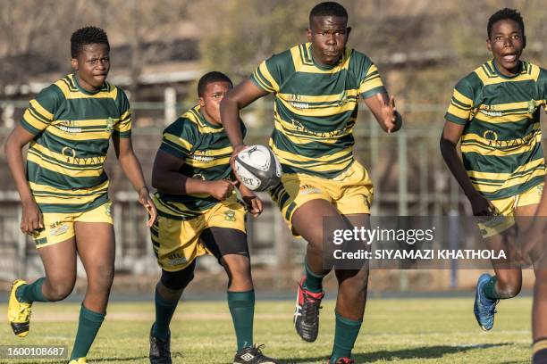Samkelo Luvuno , Thabiso Rikhotso Thando Licenga from Jabulani Technical Secondary School U16 rugby run during a match against Marist Brothers...