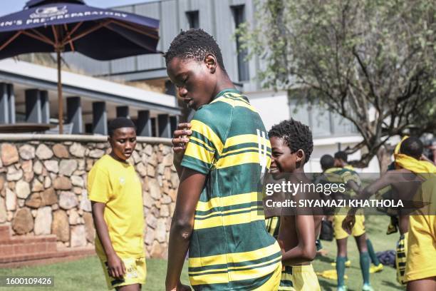 Thando Licenga from Jabulani Technical Secondary School in Soweto on May 6, 2023 wears his jersey ahead of a match against St. John College. The high...