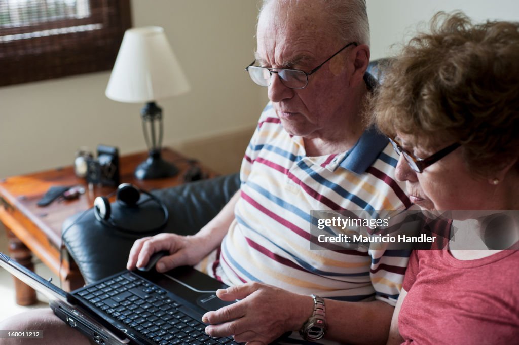 An elderly couple using wireless internet.