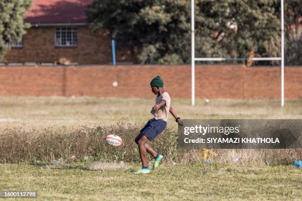 Bongani Buthelezi kicks the ball during a rugby practice at Jabulani technical Secondary School in Soweto on May 25, 2023. The high school rugby...