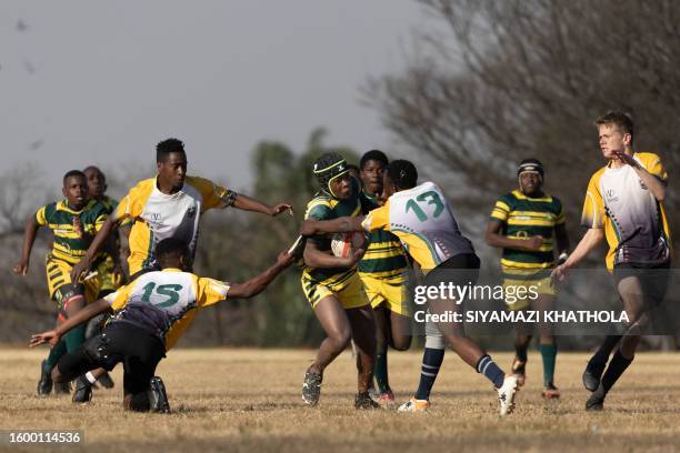 Mkhokheli Gumede from Soweto Jabulani Technical Secondary School U16 rugby team runs with the ball during a match against Vryburger high school in...