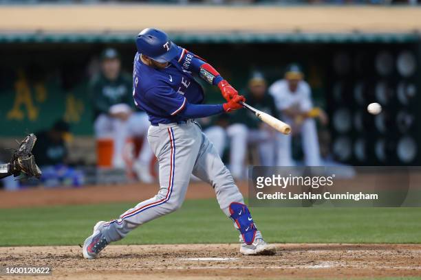 Corey Seager of the Texas Rangers hits a double in the top of the sixth inning against the Oakland Athletics at RingCentral Coliseum on August 07,...