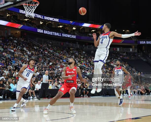 Tyrese Haliburton of the United States passes to Cam Johnson for a dunk against Christopher Ortiz of Puerto Rico in the second half of a 2023 FIBA...