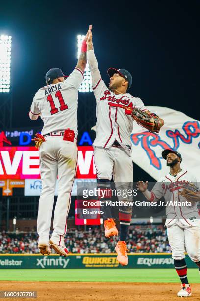 August 14: Orlando Arcia of the Atlanta Braves and Eddie Rosario high five after winning the game 11-3 against the New York Yankees at Truist Park on...
