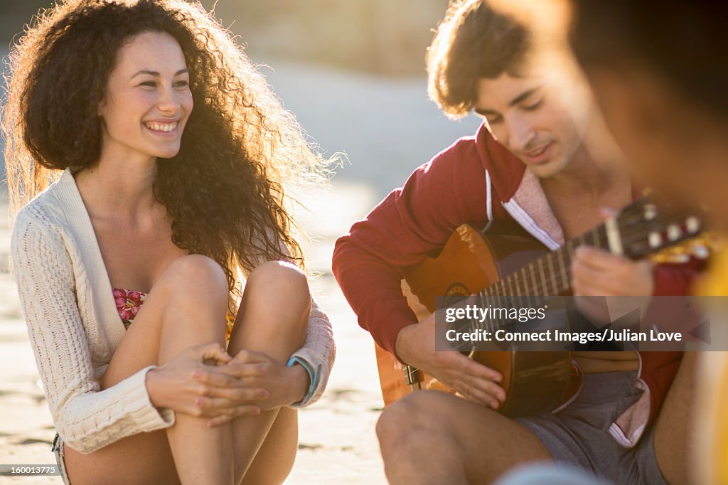 Man playing guitar for girlfriend