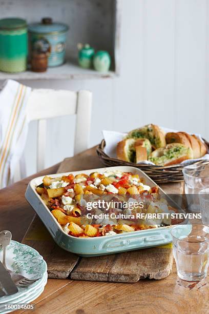 dish of bacon pasta bake - garlic bread stock pictures, royalty-free photos & images