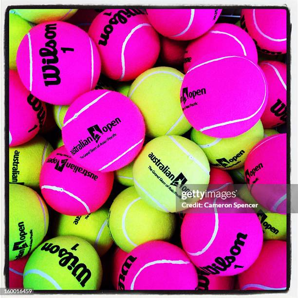 Giant tennis balls are displayed in the Australian Open merchandise store during day eight of the 2013 Australian Open at Melbourne Park on January...