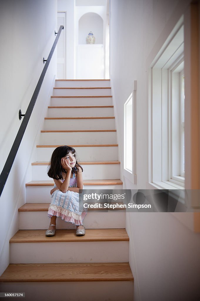 Girl sitting quietly on the stairs