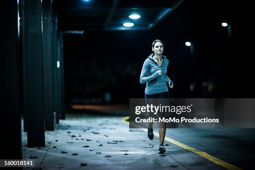 Woman running at nighttime Woman running at nighttime