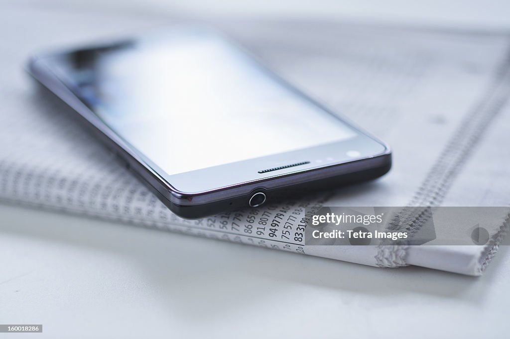 Smartphone on newspaper