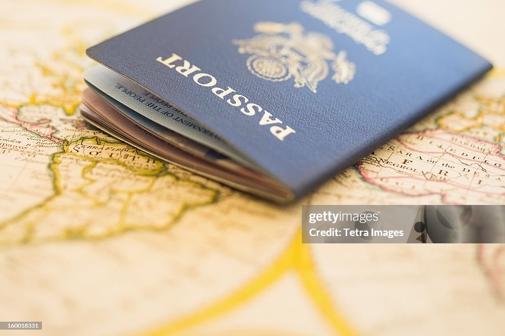 Passport sitting on antique map