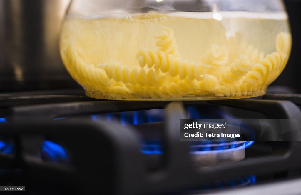 Close-up of pasta boiling on gas burner