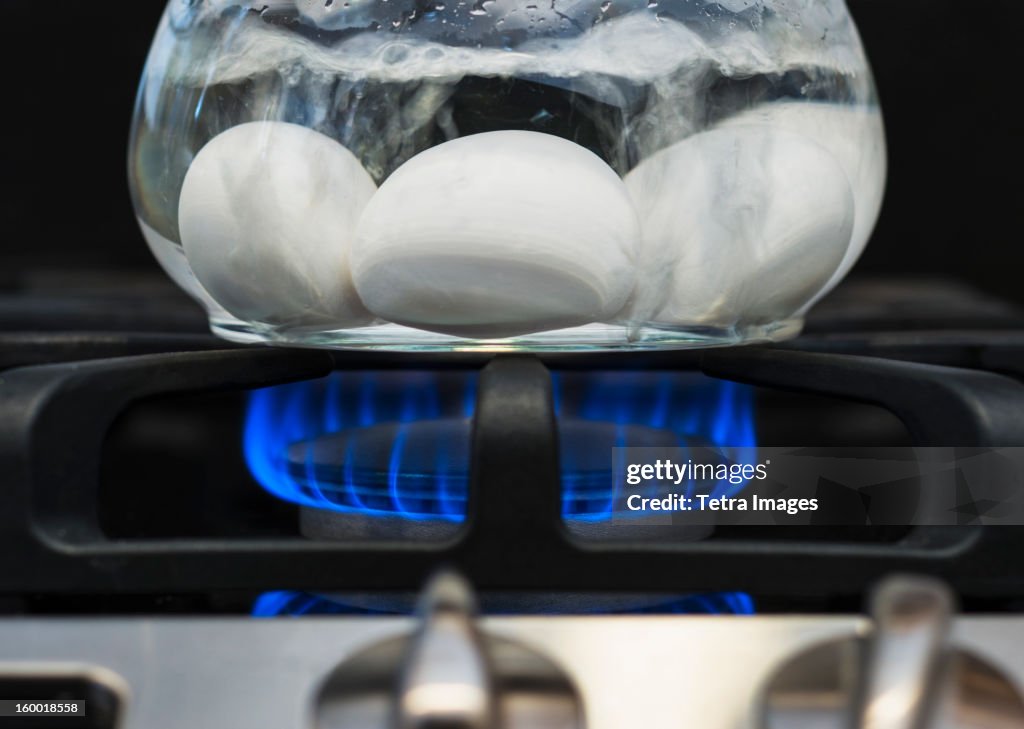 Close-up of eggs boiling on gas burner