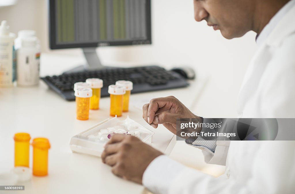 Pharmacist preparing prescription pills