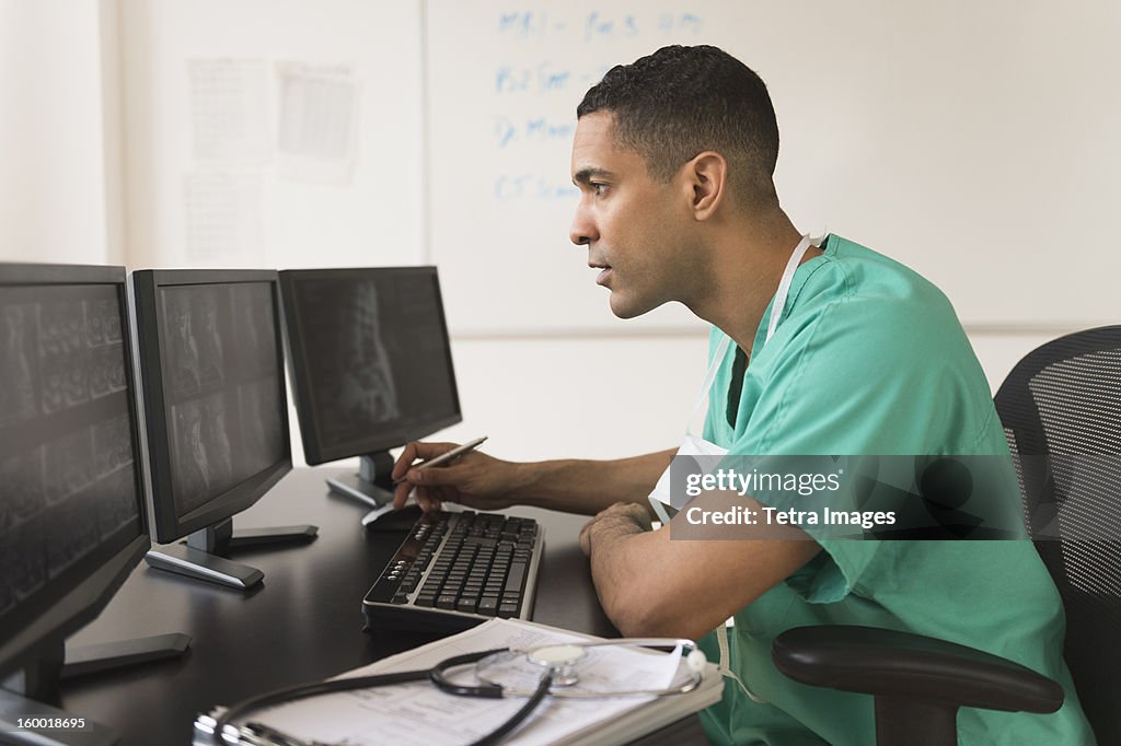 Surgeon working on computer