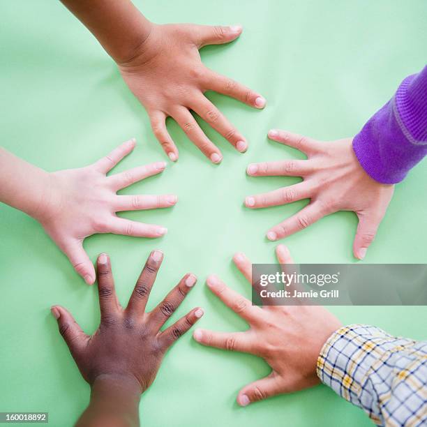 close up of children's (8-9) hands on green background - 子供のみ ストックフォトと画像