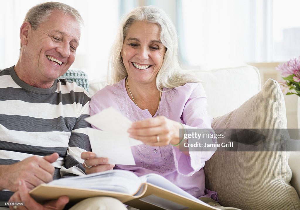 Portrait of elderly couple watching photos