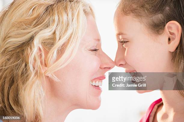 mother and daughter (8-9 years) rubbing with noses - 8 9 years stock-fotos und bilder