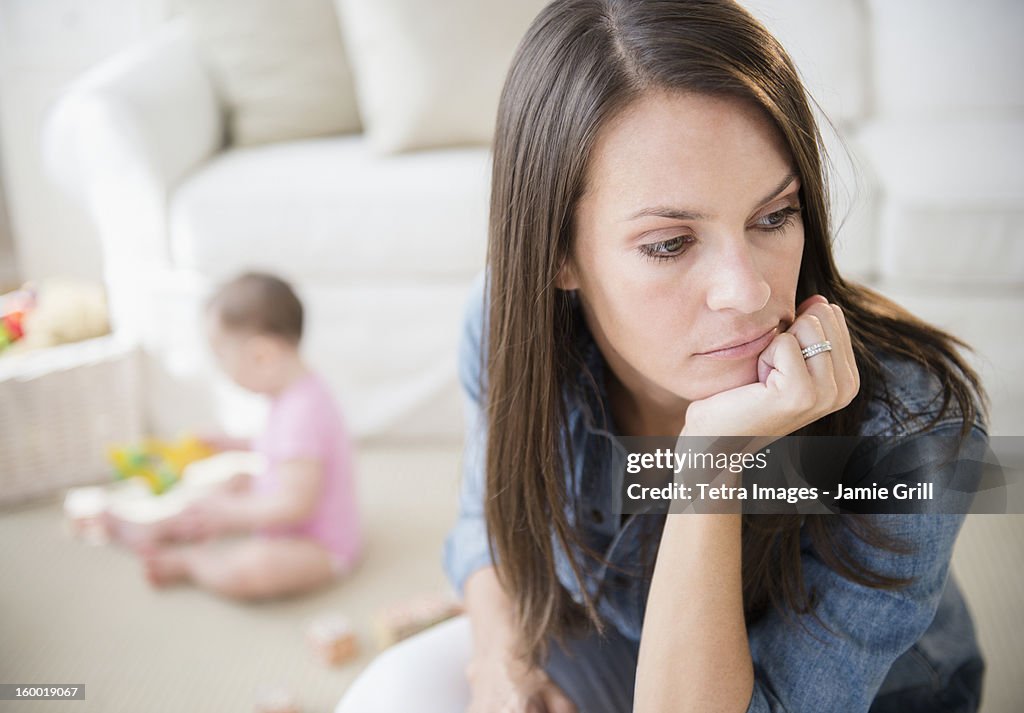 Mother with daughter (6-11 months) in living room