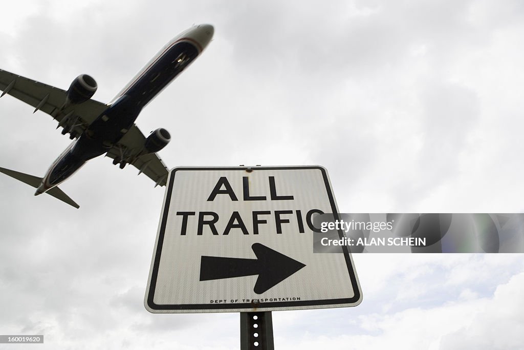 USA, New York State, New York City, Airplane flying above road signs