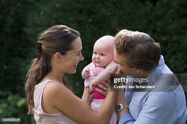 netherlands, mijnsheerenland, family with baby daughter (6-11 months) in park - mijnsheerenland stock pictures, royalty-free photos & images