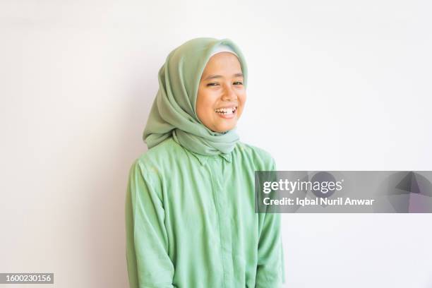 cheerful asian muslim girl with toothy smile on white background - veil isolated stock pictures, royalty-free photos & images
