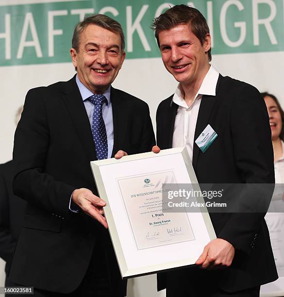 President Wolfgang Niersbach hands over the certificate to DFB Science Award winner Georg Froese during the DFB Science Congress 2013 at the...