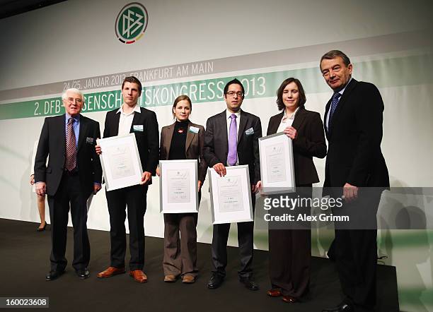 President Wolfgang Niersbach and Martin-Peter Buech , head of the DFB Science department, pose with the DFB Science Award winners Georg Froese, Marie...