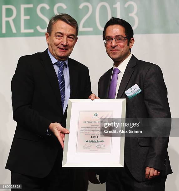 President Wolfgang Niersbach hands over the certificate to DFB Science Award second placed Stefan Chatrath during the DFB Science Congress 2013 at...