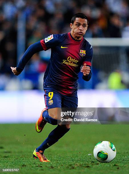 Alexis Sanchez of FC Barcelona runs with the ball during the Copa del Rey Quarter Final 2nd leg match between Malaga CF and FC Barcelona at La...