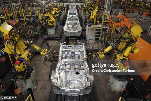 Robotic arms assemble and weld the body shell of a Nissan car on the production line at Nissan's Sunderland plant on January 24, 2013 in Sunderland,...