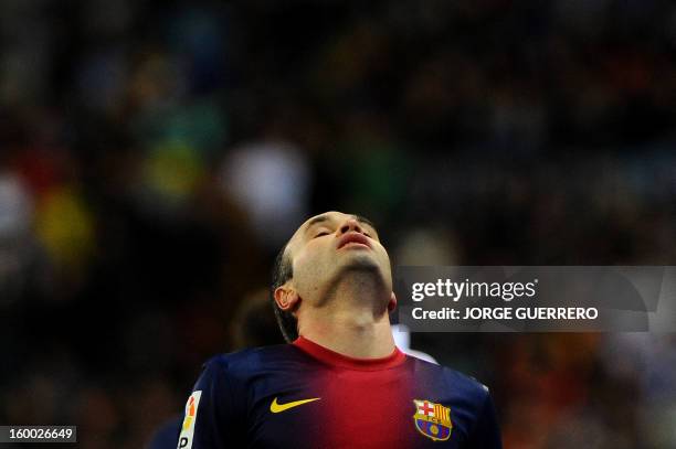 Barcelona's midfielder Andres Iniesta reacts during the Spanish Copa del Rey quarter-final second leg football match Malaga CF vs FC Barcelona at the...