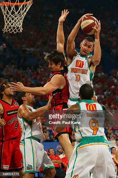 Russell Hinder of the Crocodiles rebounds against Greg Hire of the Wildcats during the round 16 NBL match between the Perth Wildcats and the...