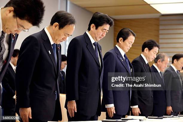 Prime Minister Shinzo Abe and ministers offer silent prayer prior to an emergency meeting on the Algerian hostage crisis at Abe's official residence...