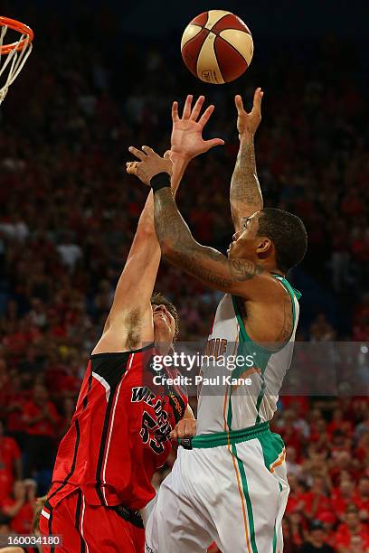 Gary Ervin of the Crocodiles shoots against Damian Martin of the Wildcats during the round 16 NBL match between the Perth Wildcats and the Townsville...