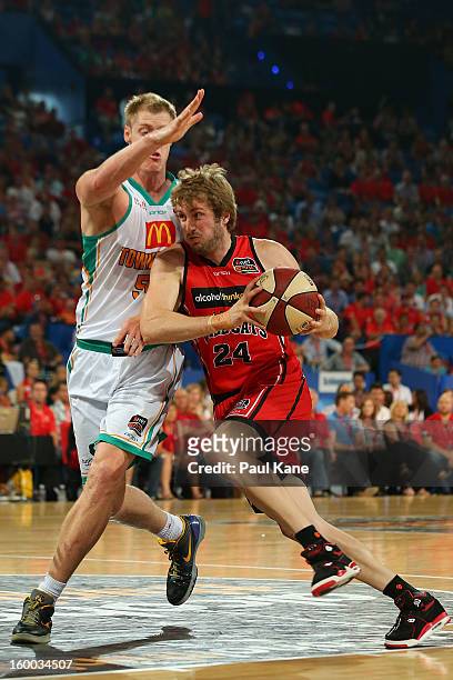 Jesse Wagstaff of the Wildcats drives to the basket against Luke Nevill of the Crocodiles during the round 16 NBL match between the Perth Wildcats...