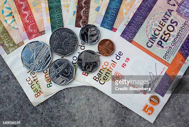 Mixed denomination convertible peso, or "chavito," notes and coins, one of two official currencies in Cuba, are seen in this arranged photograph in...