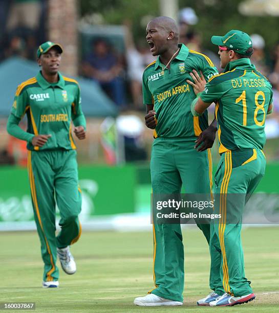 Lonwabo Tsotsobe of South Africa celebrates with team-mate Faf du Plessis after claiming the wicket of Martin Guptill during the 3rd One Day...