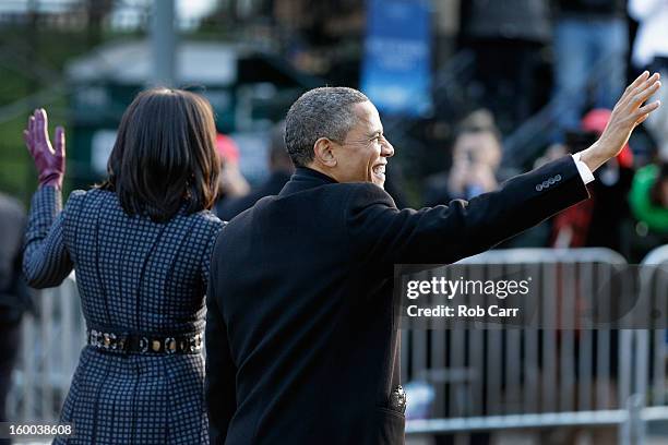 President Barack Obama and first lady Michelle Obama walk the route as the presidential inaugural parade winds through the nation's capital January...