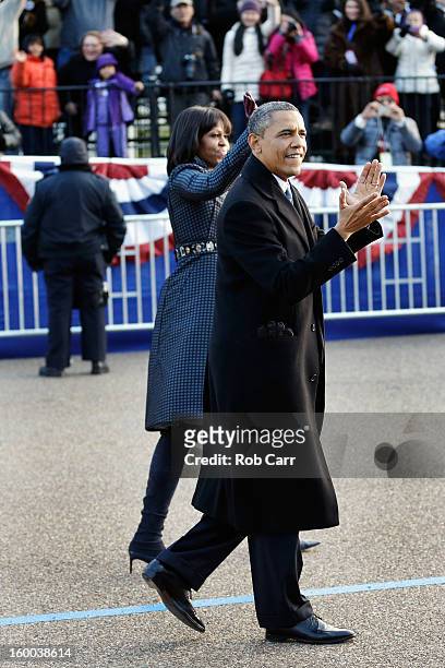 President Barack Obama and first lady Michelle Obama walk the route as the presidential inaugural parade winds through the nation's capital January...