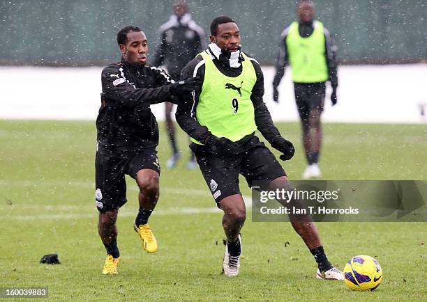 Shola Ameobi under pressure from Vurnon Anita during a Newcastle United training session at the Little Benton training ground on January 25, 2013 in...