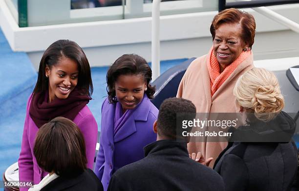 The daughters of U.S. President Barack Obama, Sasha Obama and Malia Obama and mother-in-law Marian Robinson look on followoing the presidents public...