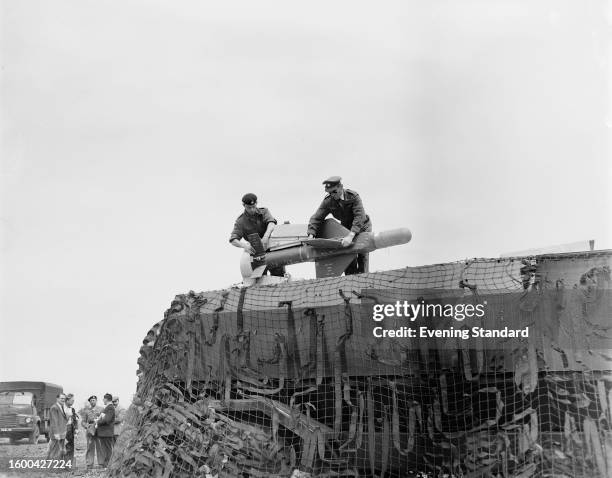 Two soldiers assemble a Malkara guided anti-tank missile atop a camouflaged armoured vehicle, June 28th 1960.