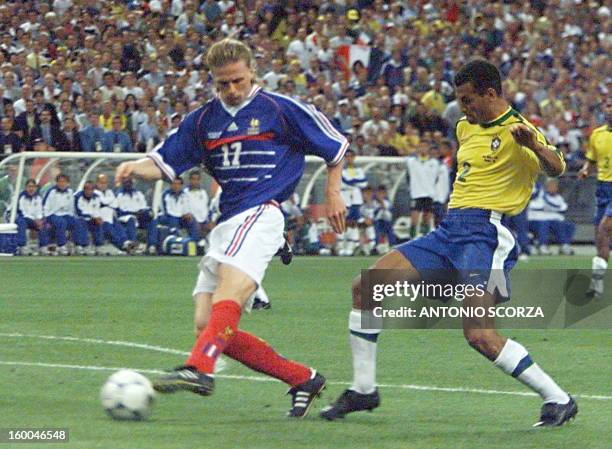 - French Emmanuel Petit is challenged by Brazilian Cafu on his way to score the third goal for his team 12 July at the Stade de France in...