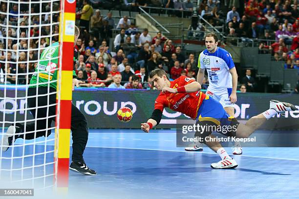 Julen Aguinagalde of Spain scores a goal against Gorzad Skof of Slovenia during the Men's Handball World Championship 2013 semi final match between...