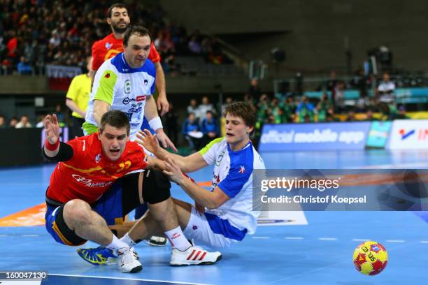 Jure Dolenec of Slovenia defends against Julen Aguinagalde of Spain during the Men's Handball World Championship 2013 semi final match between Spain...