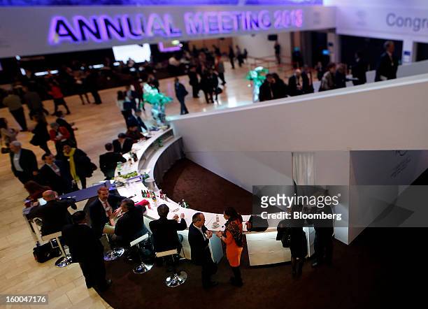 Attendees take break at lunchtime during sessions in this photo taken with a tilt shift lens on day three of the World Economic Forum in Davos,...