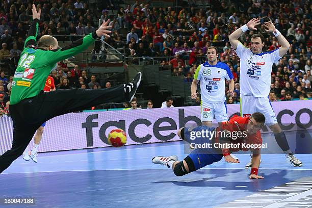 Julen Aguinagalde of Spain scores a goal Gorzad Skof of Slovenia during the Men's Handball World Championship 2013 semi final match between Spain and...