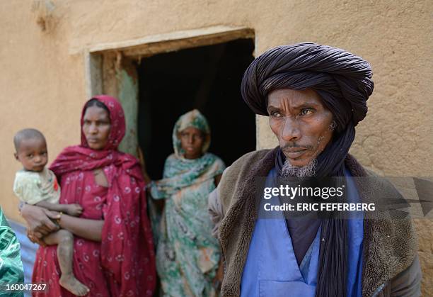 Ali Ag Noh poses on January 25, 2013 with his wife Zahra , his daughter and his son Aboubacrim in front of his house in the village of Seribala, 20...