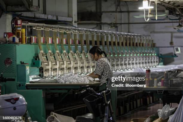 Worker at a textile workshop in Guangzhou, China, on Thursday, Aug. 10, 2023. China's central bank unexpectedly reduced a key interest rate by the...